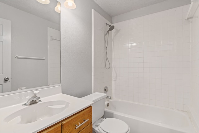 full bathroom featuring vanity, a textured ceiling, toilet, and tiled shower / bath combo