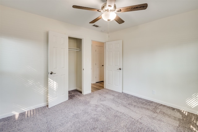 unfurnished bedroom with light carpet, a closet, and ceiling fan