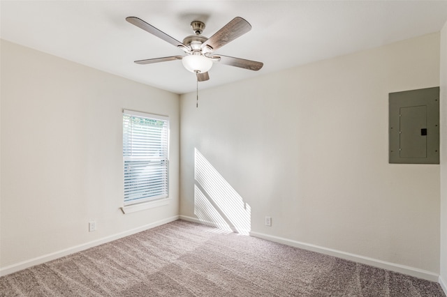 carpeted empty room with ceiling fan and electric panel