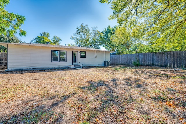 rear view of property with cooling unit