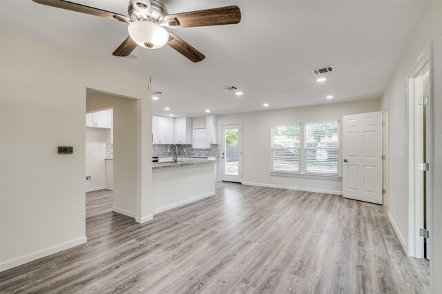 kitchen featuring sink, stainless steel dishwasher, and white cabinets