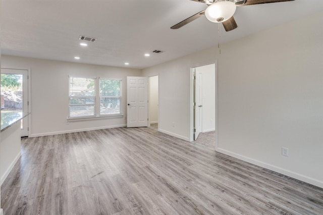 spare room with light hardwood / wood-style floors and ceiling fan