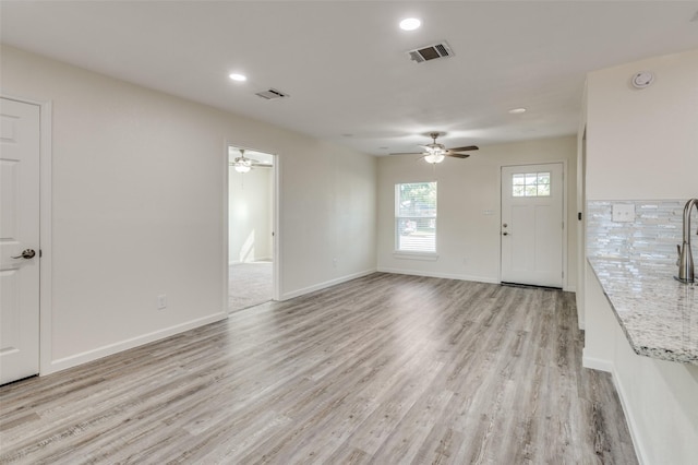 interior space featuring ceiling fan and light wood-type flooring