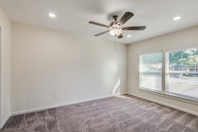 carpeted empty room featuring ceiling fan