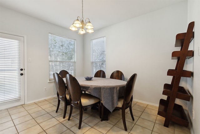 dining room featuring a chandelier and light tile patterned floors