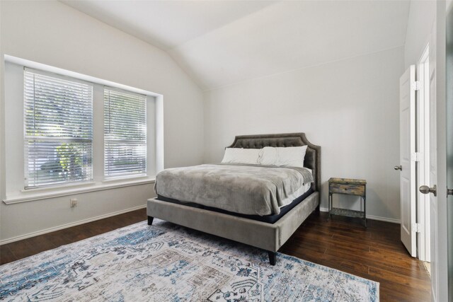 bedroom with dark hardwood / wood-style flooring and lofted ceiling