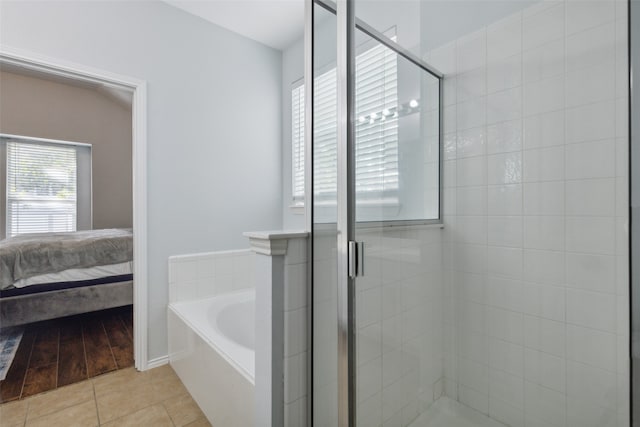 bathroom featuring tile patterned flooring and plus walk in shower