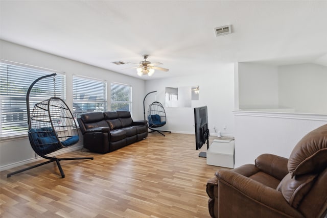 living room featuring light hardwood / wood-style floors and ceiling fan