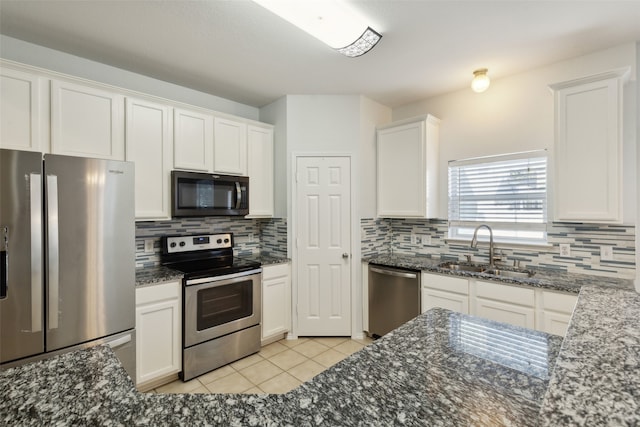 kitchen featuring tasteful backsplash, white cabinetry, appliances with stainless steel finishes, and sink