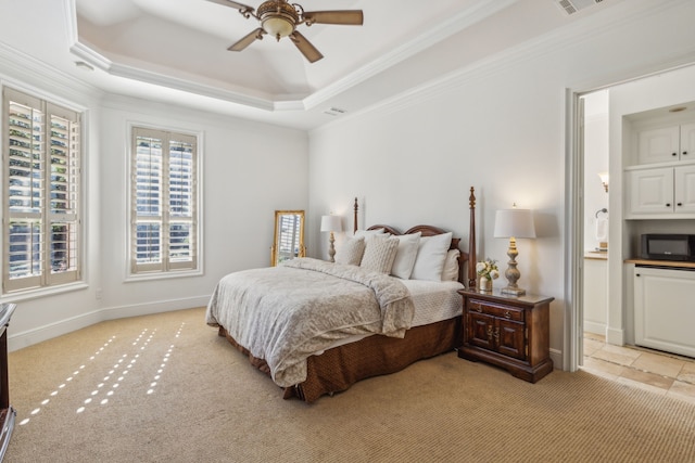 bedroom featuring light colored carpet, a raised ceiling, ceiling fan, and crown molding