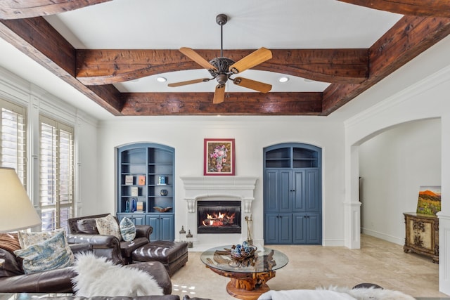 living room with a tray ceiling and ceiling fan