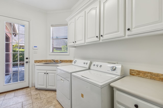 laundry room featuring cabinets, a healthy amount of sunlight, washer and clothes dryer, and ornamental molding