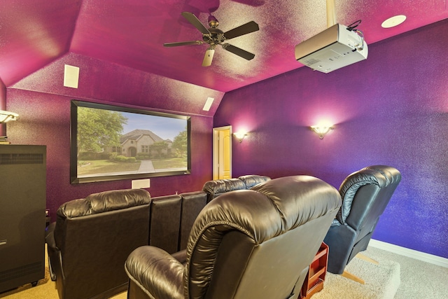 carpeted cinema with ceiling fan and lofted ceiling