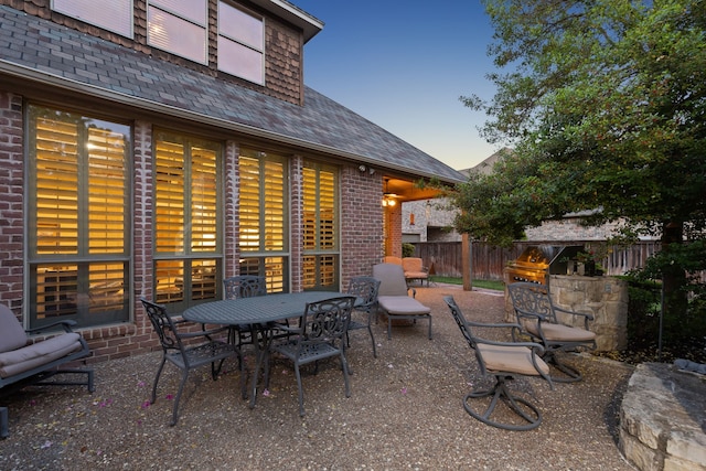 patio terrace at dusk with a grill