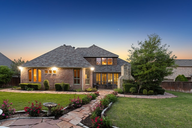 view of front of property featuring a yard and a patio area