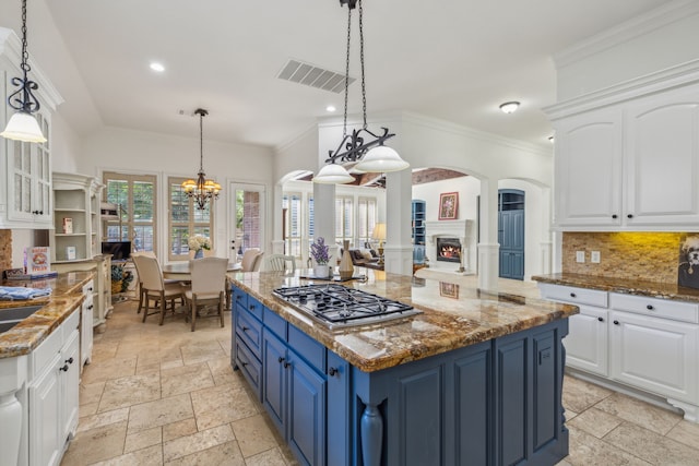 kitchen featuring blue cabinetry, white cabinetry, and stainless steel gas stovetop