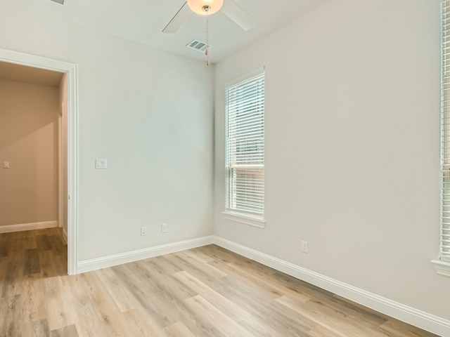 spare room featuring ceiling fan and light hardwood / wood-style flooring