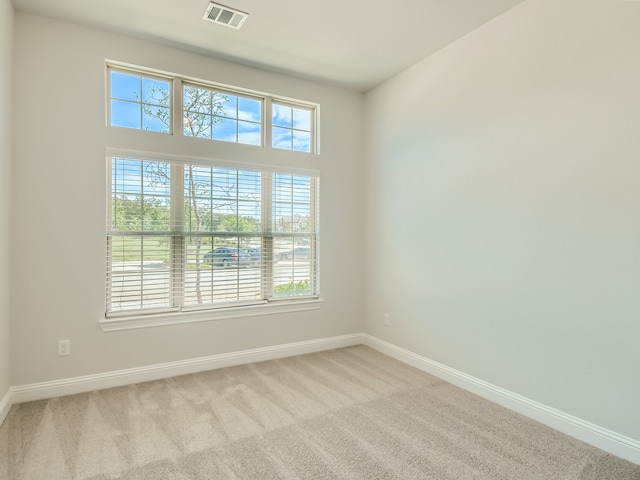 carpeted empty room featuring a healthy amount of sunlight