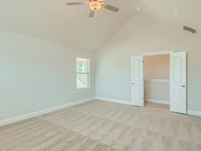 interior space featuring high vaulted ceiling, light carpet, and ceiling fan