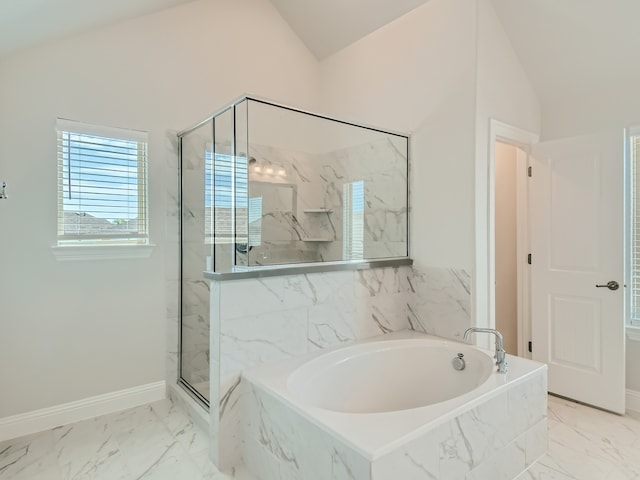 bathroom with shower with separate bathtub and high vaulted ceiling