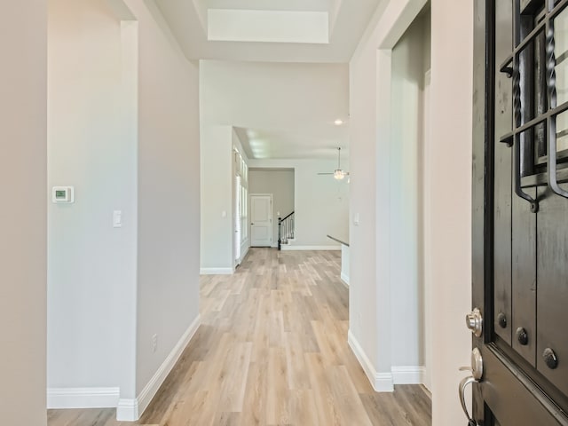 interior space with a skylight and light hardwood / wood-style flooring