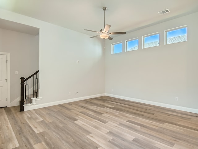 empty room featuring ceiling fan and light hardwood / wood-style flooring