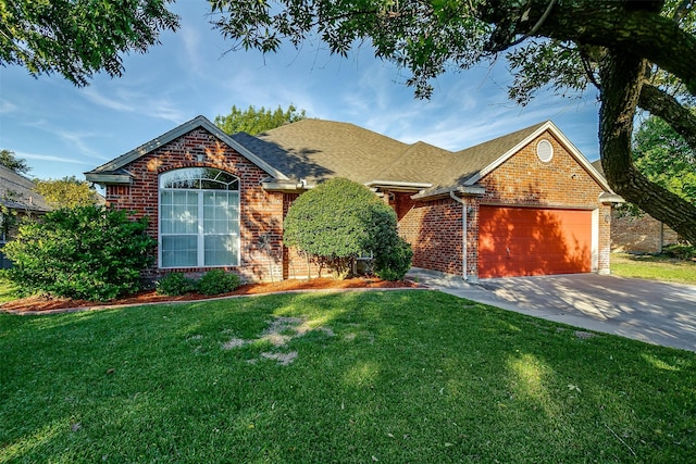 view of front of home featuring a garage and a front yard