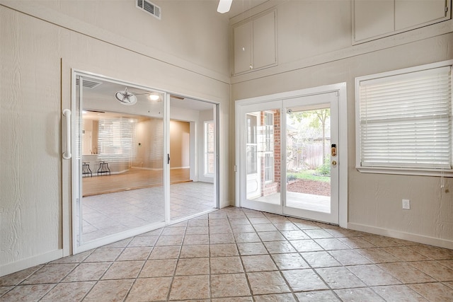 doorway with ceiling fan