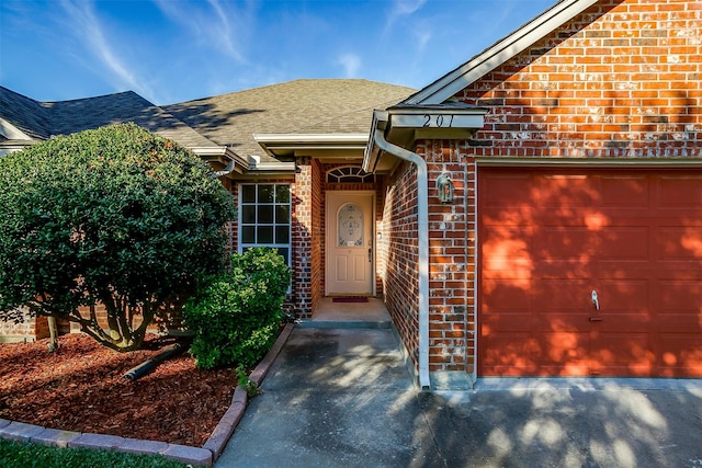 view of exterior entry with a garage