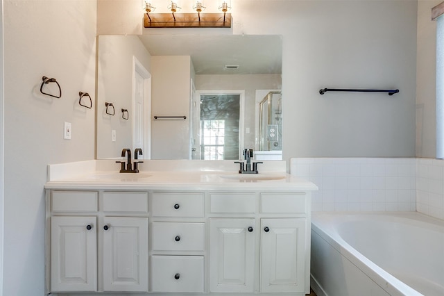 bathroom featuring vanity and a tub to relax in