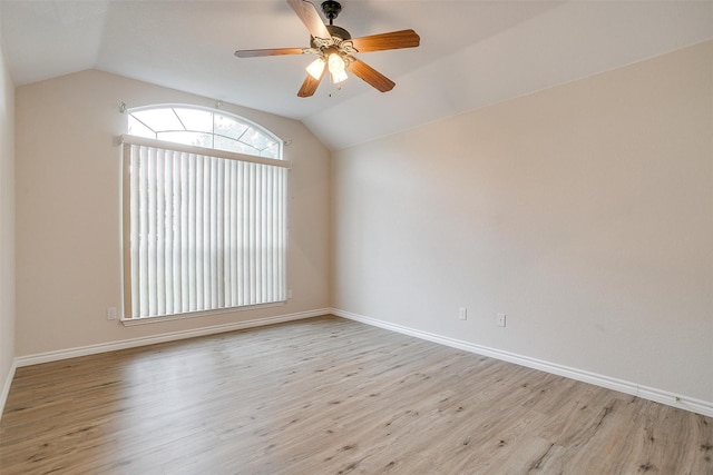 empty room with light hardwood / wood-style floors, ceiling fan, and vaulted ceiling