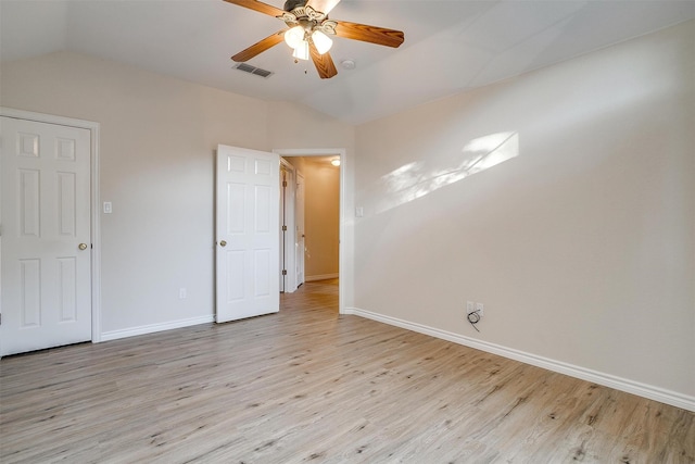 empty room with ceiling fan, light wood-type flooring, and lofted ceiling