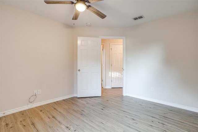 empty room with light hardwood / wood-style floors and ceiling fan