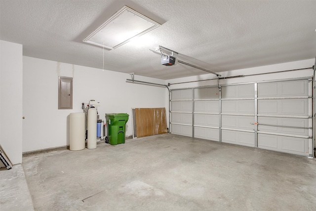 garage with electric panel and a garage door opener