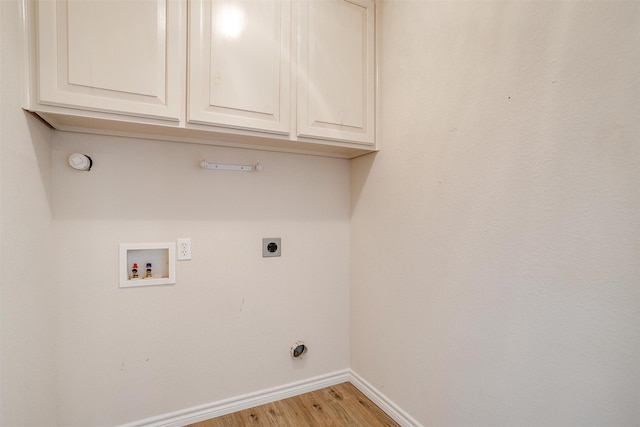 laundry room with hookup for an electric dryer, light hardwood / wood-style floors, cabinets, and hookup for a washing machine