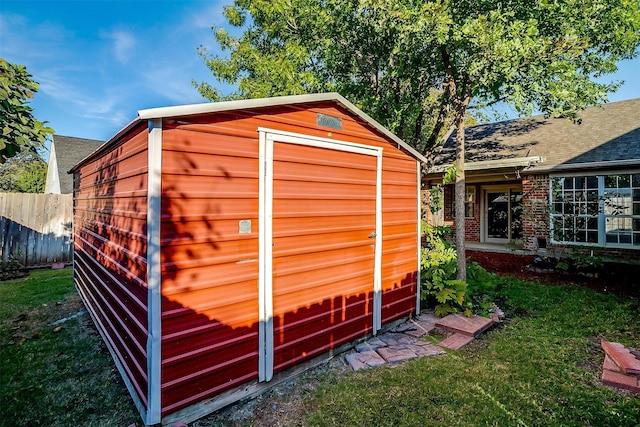 view of outbuilding with a yard