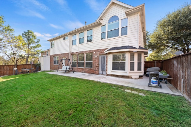 rear view of property featuring a patio area and a yard