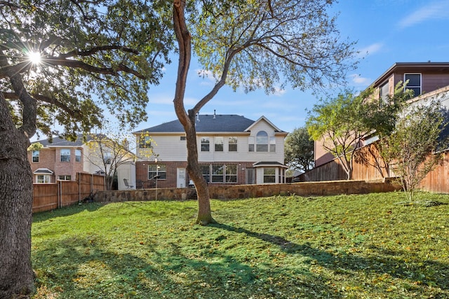 rear view of house featuring a yard