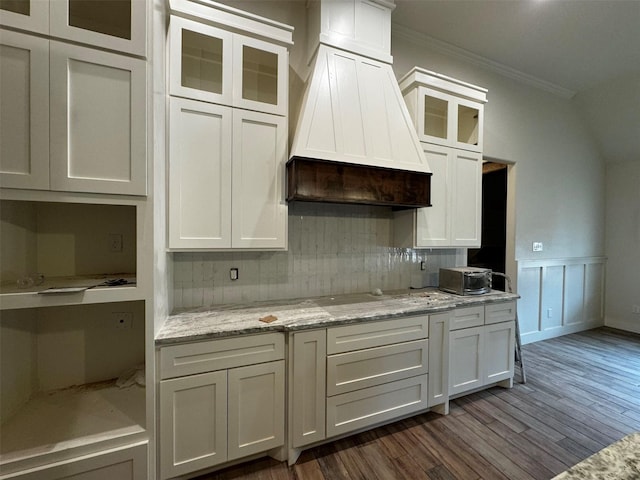 kitchen with white cabinetry, crown molding, and premium range hood