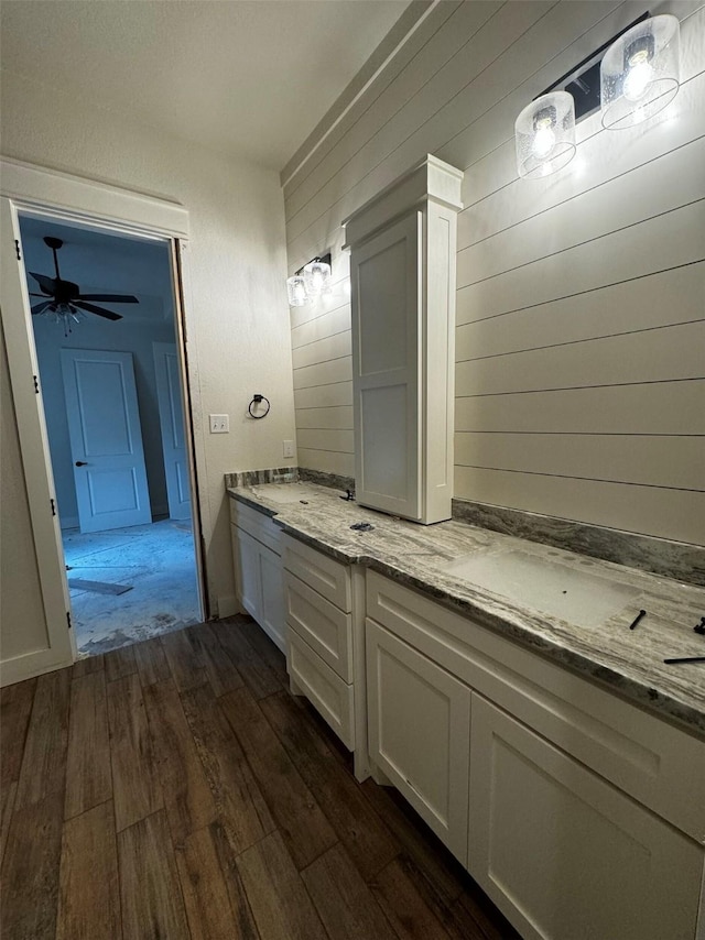 bathroom with ceiling fan, vanity, and hardwood / wood-style flooring