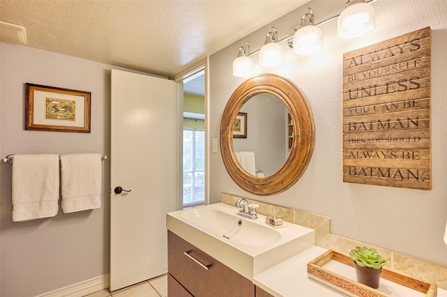 bathroom with vanity, a textured ceiling, and tile patterned floors