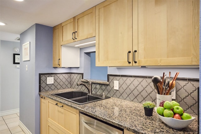 kitchen featuring dishwasher, decorative backsplash, sink, and light stone counters