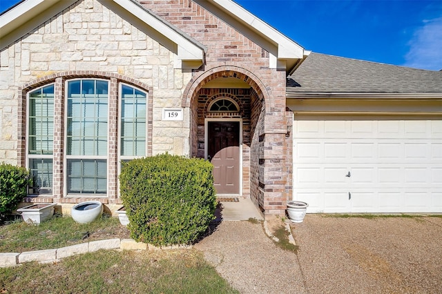 view of exterior entry featuring a garage