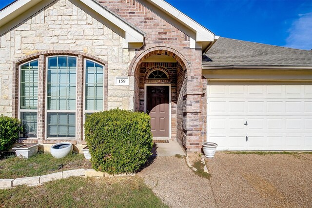 view of exterior entry featuring a garage