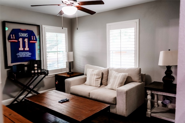 living room featuring ceiling fan and a healthy amount of sunlight