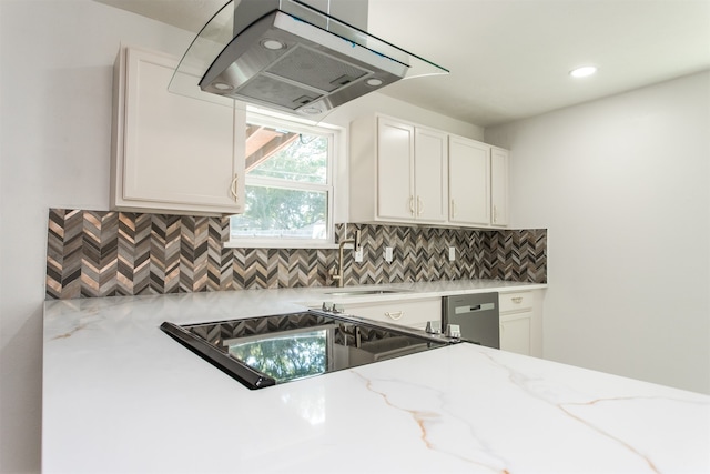 kitchen featuring decorative backsplash, ventilation hood, sink, and white cabinets