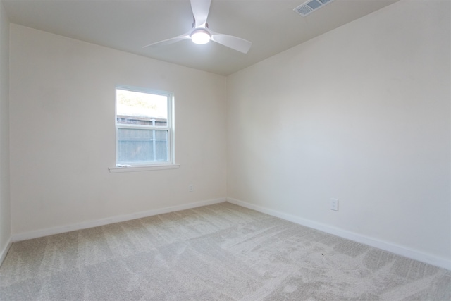 spare room featuring ceiling fan and light colored carpet