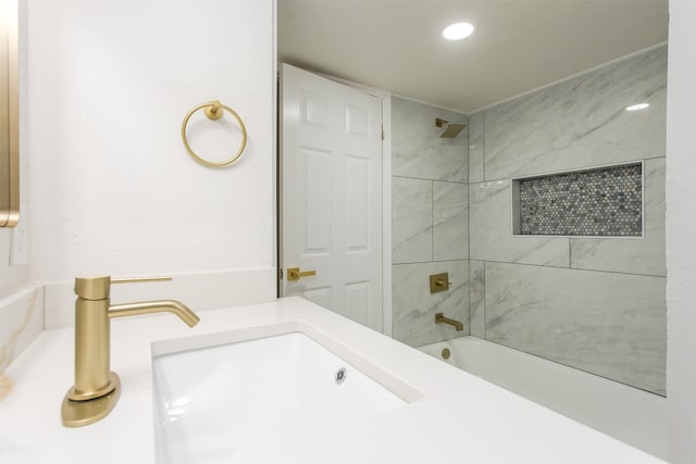 bathroom with tiled shower / bath and sink