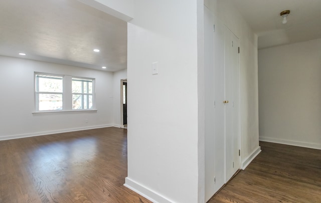 corridor with dark hardwood / wood-style flooring