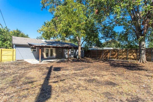 rear view of property with french doors